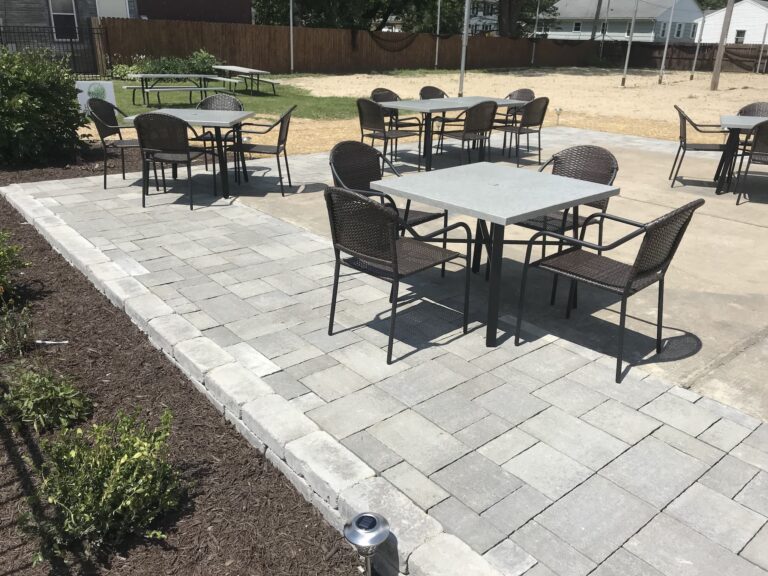 Outdoor patio with tables and chairs.